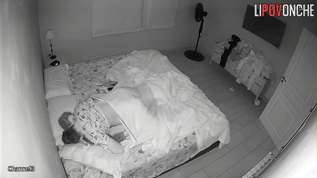 The husband slips his hands under his wife's panties, eagerly licking her nipples