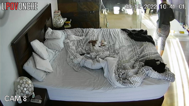 A stunning teacher relaxes in bed with her breasts exposed after showering