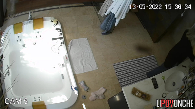An older teacher with big tits washes her shaved pussy in the bathtub