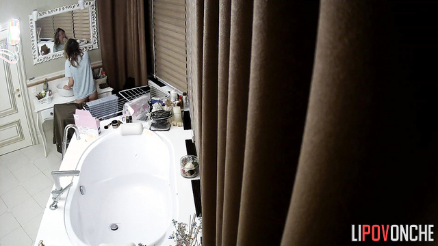 Beauty brushing her teeth in a luxurious bathroom