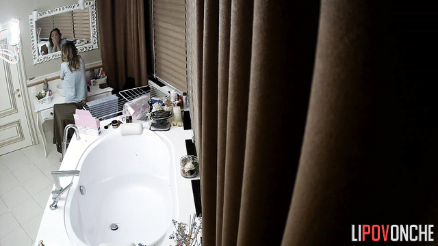 Beauty brushing her teeth in a luxurious bathroom