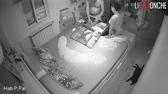 Couple packing a suitcase for a trip (pregnant wife and husband)