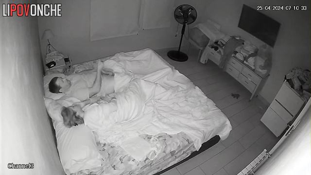 Spouses teasing each other under the blanket, look