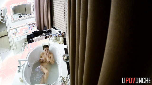 Blonde likes to text while sitting in the bath, look