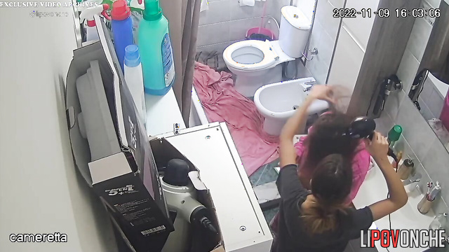 Sexy girl dries her naked lesbian girlfriend's hair with a hair dryer after a shower
