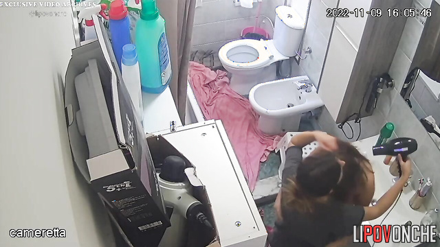Sexy girl dries her naked lesbian girlfriend's hair with a hair dryer after a shower