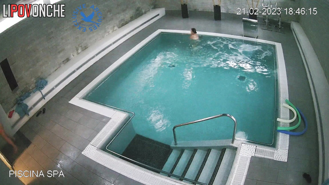Women chatting and swimming in the public pool, look