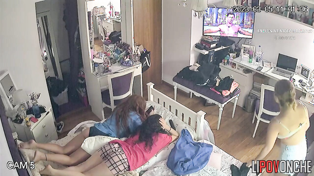 Two bored lesbian girlfriends try on new bras and outfits in their shared bedroom
