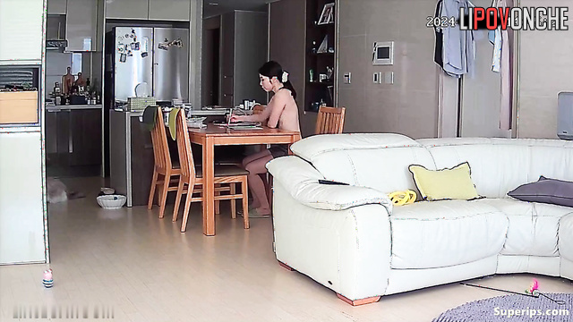 A skinny Asian girl with small tits prefers to walk around the house topless