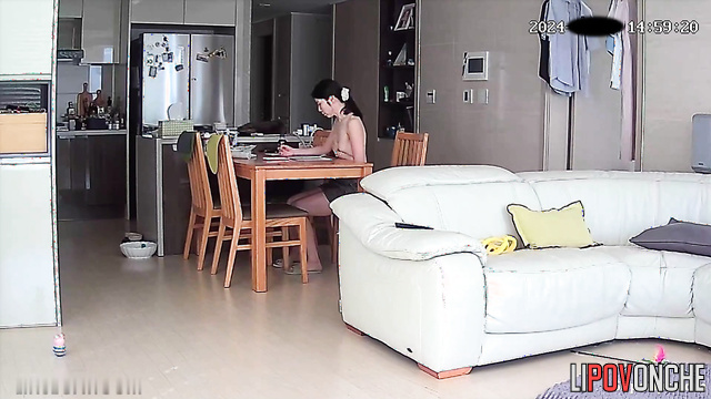 A skinny Asian girl with small tits prefers to walk around the house topless