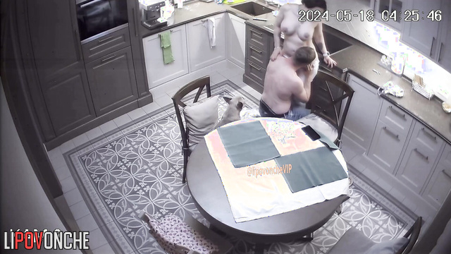 Husband and wife kissing and hugging topless at the kitchen